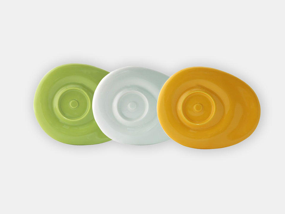 Three saucers for cup, one green, one white and one yellow