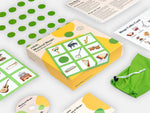 Layed-out components of the Relish Musical Audio Bingo Game with its green colours.