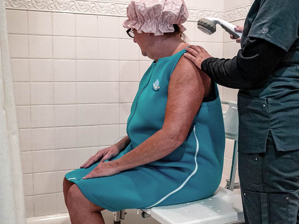 A lady getting showered with the Blue Hug