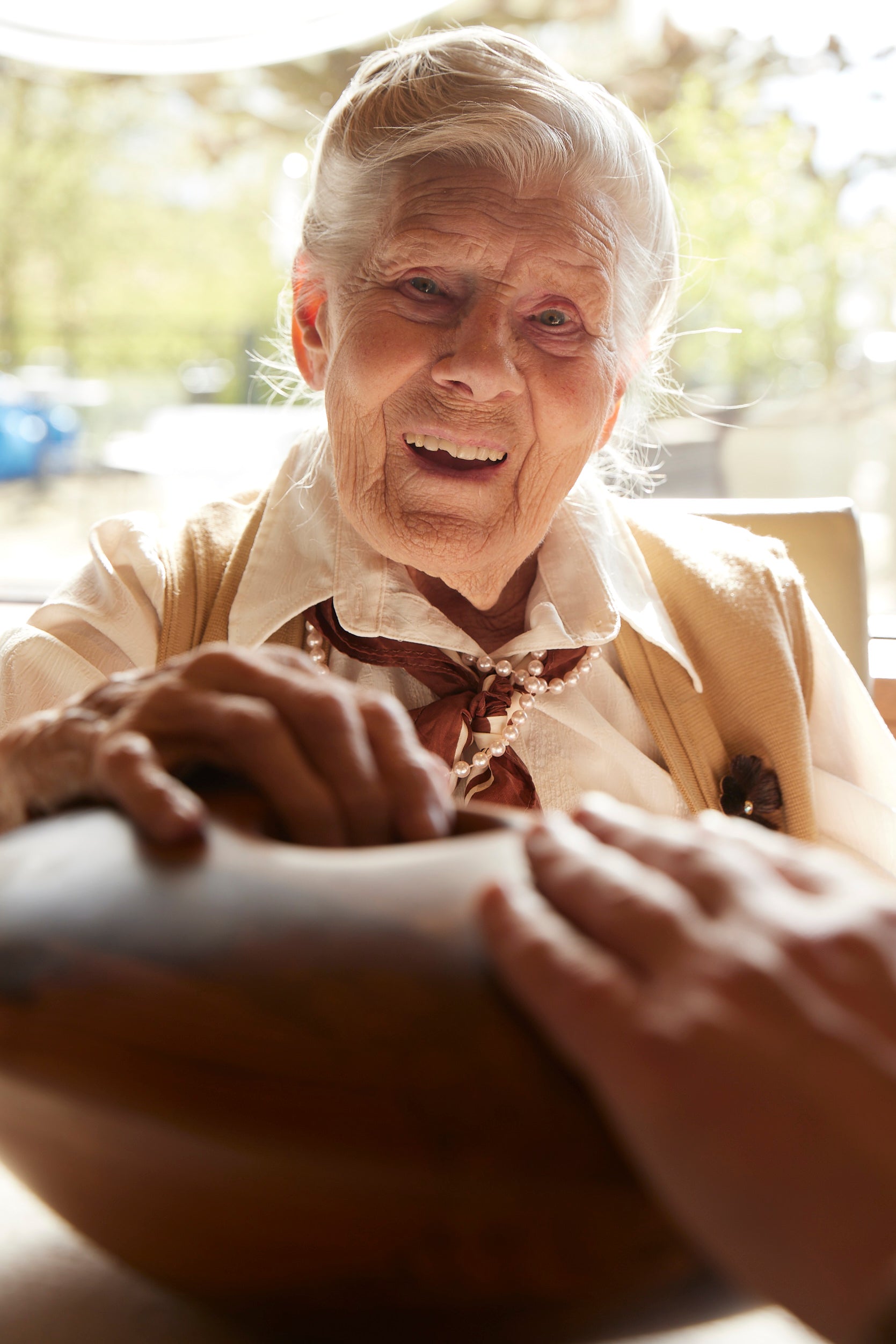 Older woman smiling and interacting with the Crdl