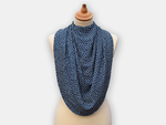 The dignifying protective pashmina bib for older adults in the navy blue with white polka dots pattern.