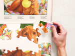 Close-up of a hand adding a piece to an adapted 13-piece Relish puzzle for people living with dementia.