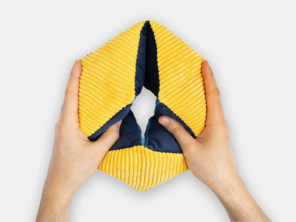 Hands holding the yellow and blue rhythmic Relish tactile-turn designed for fidgety hands.