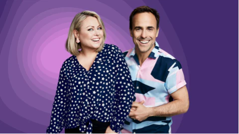 Mitsou Gélinas and Sébastien Benoit in front of a purple background