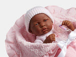 Close-up of the African-American doll ''La Newborn'' wrapped in a pink blanket with her baby bottle.