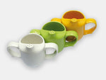 Angled top view of a white, a green, and a yellow mug, all designed to maintain dignity during mealtimes.