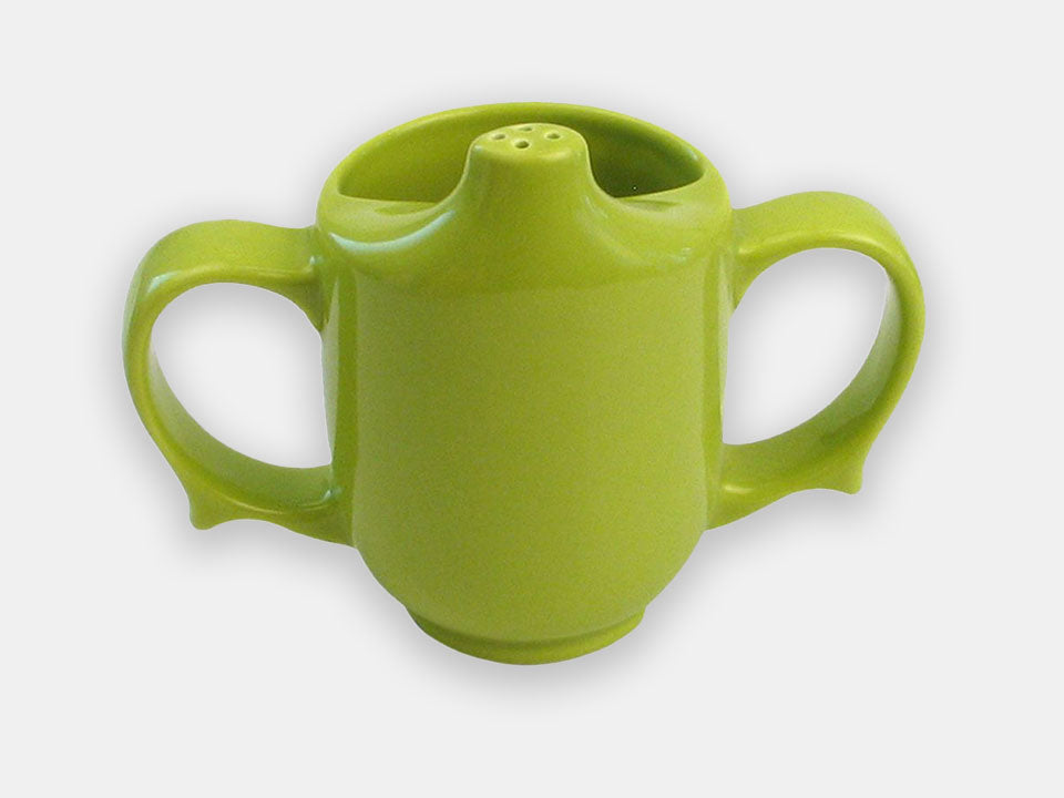 Front view of the green two-handle dignity cup that maintains independance by helping to prevent spills.