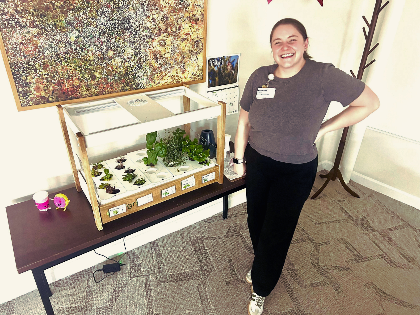 Activity director standing next to the Eldergrow Compact Garden