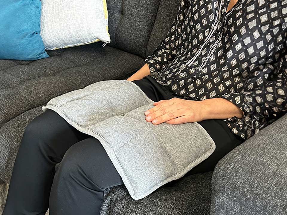 The Fiora Weighed lap pad on a woman