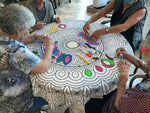 A group of elderly residents coloring a Bimoo washable mandala tablecloth.