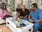 A group of seniors smiling while playing The Game of Life Generations. 