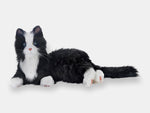 The tuxedo companion cat from Joy for All, for people living with dementia, laying on its side.