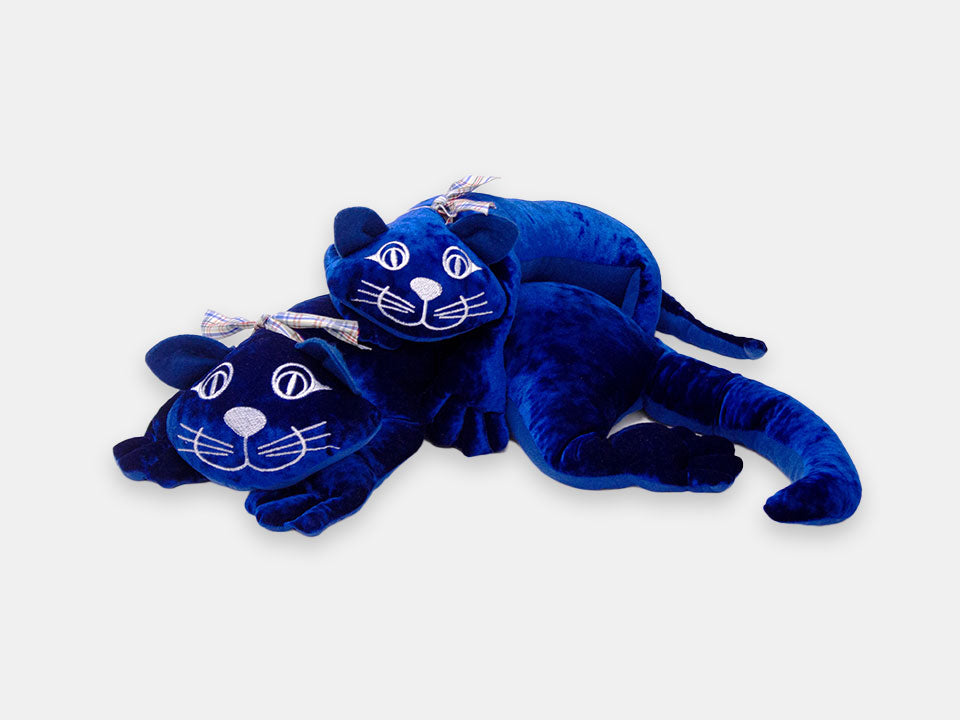 Two Manimo dark blue plush cats: comforting with their weight for people living with dementia.