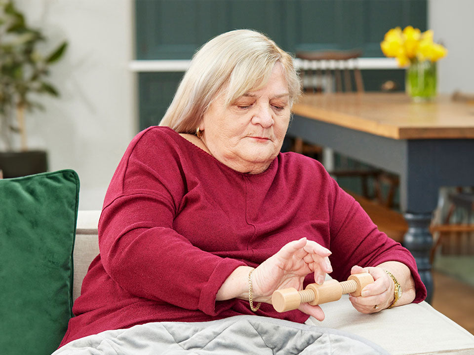 older woman playing with fidget widget