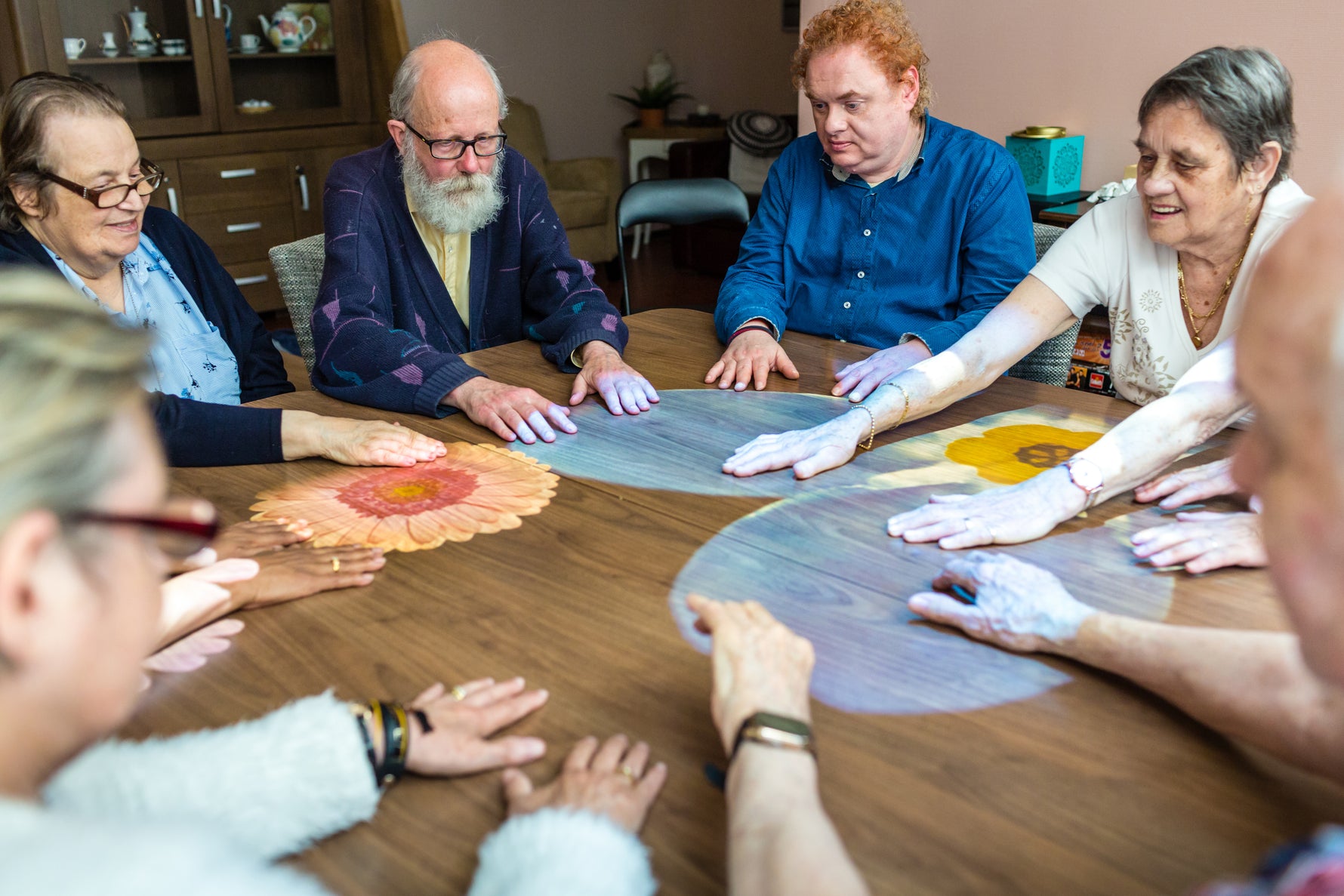 Group of people around a table playing on the Tovertafel.