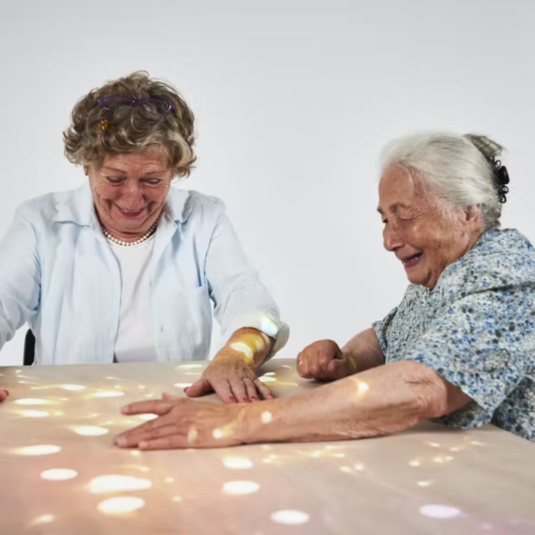 The Tovertafel magic table being used by the older woman