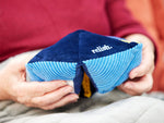 Hands holding the rhythmic Relish tactile-turn, a toy for people with fidgety hands living with dementia.