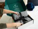 Person unboxing the Fiora weighted sensory blanket.